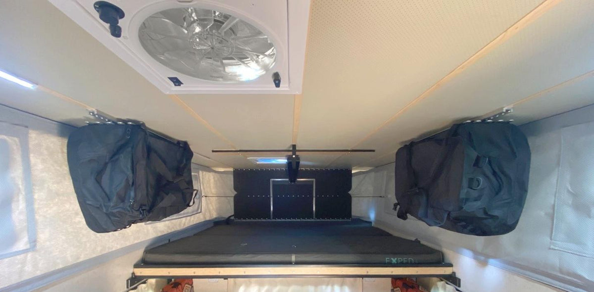 Four Wheel Camper storage idea: a Patagonia duffel hung from each side of the ceiling with LoftLockers