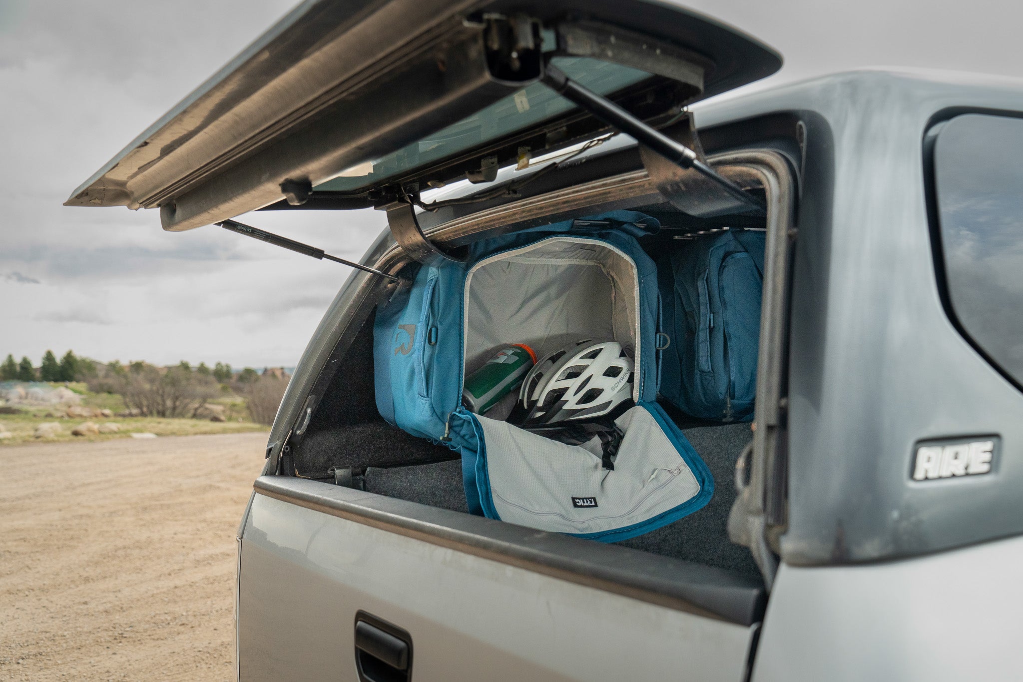 LoftLockers maximize truck topper camping space by hanging duffels as storage