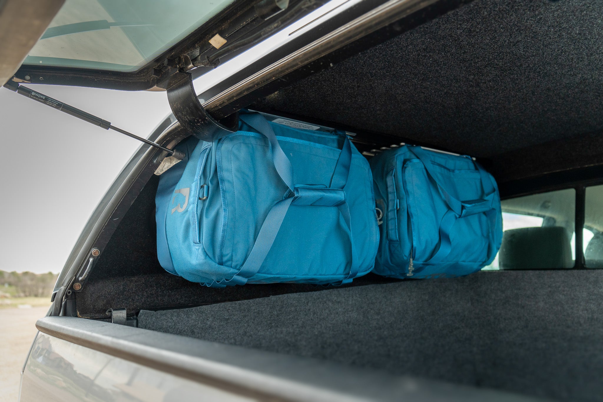 Keep gear off the bed by hanging duffels in truck toppers for truck bed camping