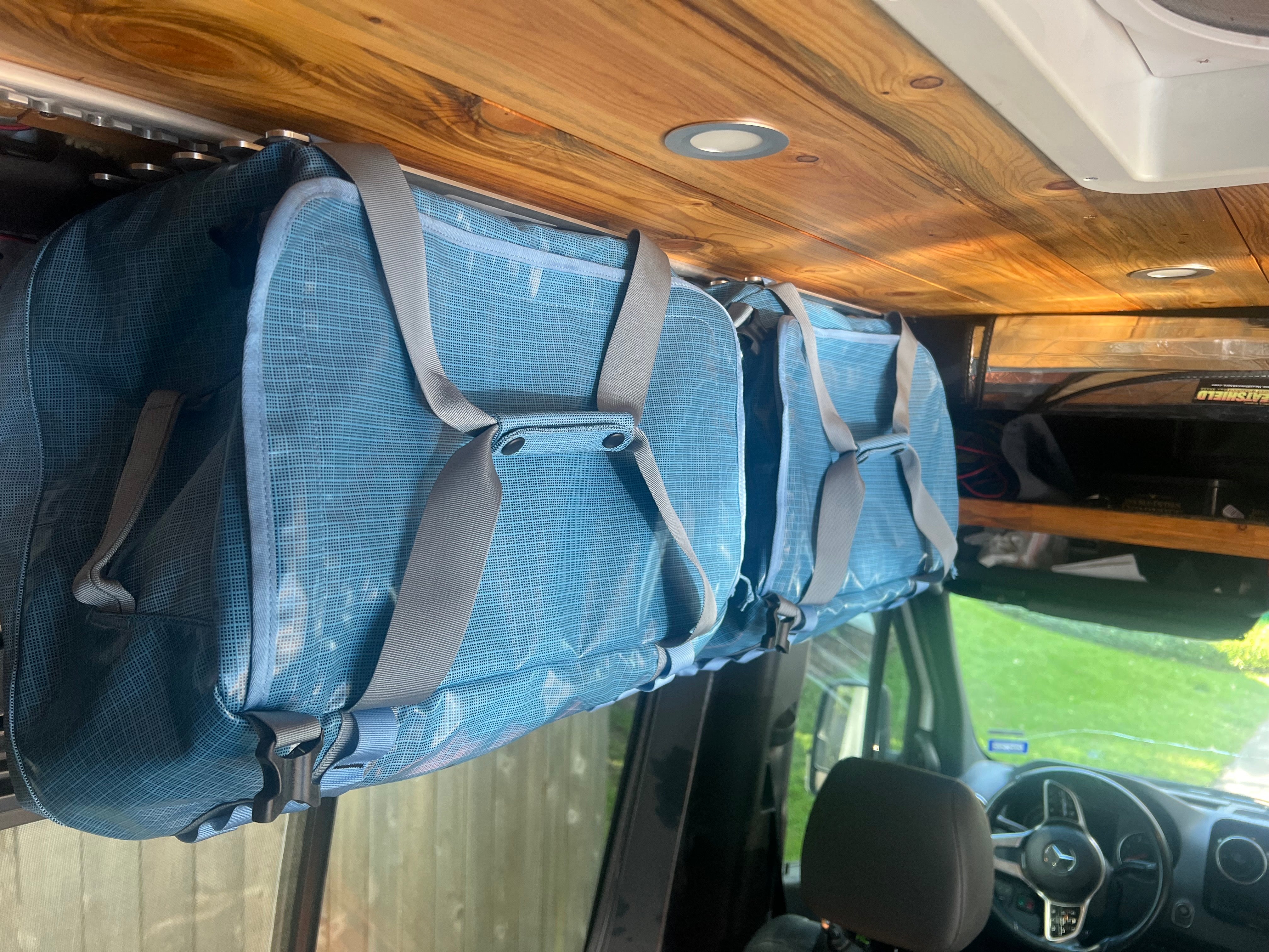 LoftLockers hang duffels as cabinets or shelves to be used as boat storage organizers